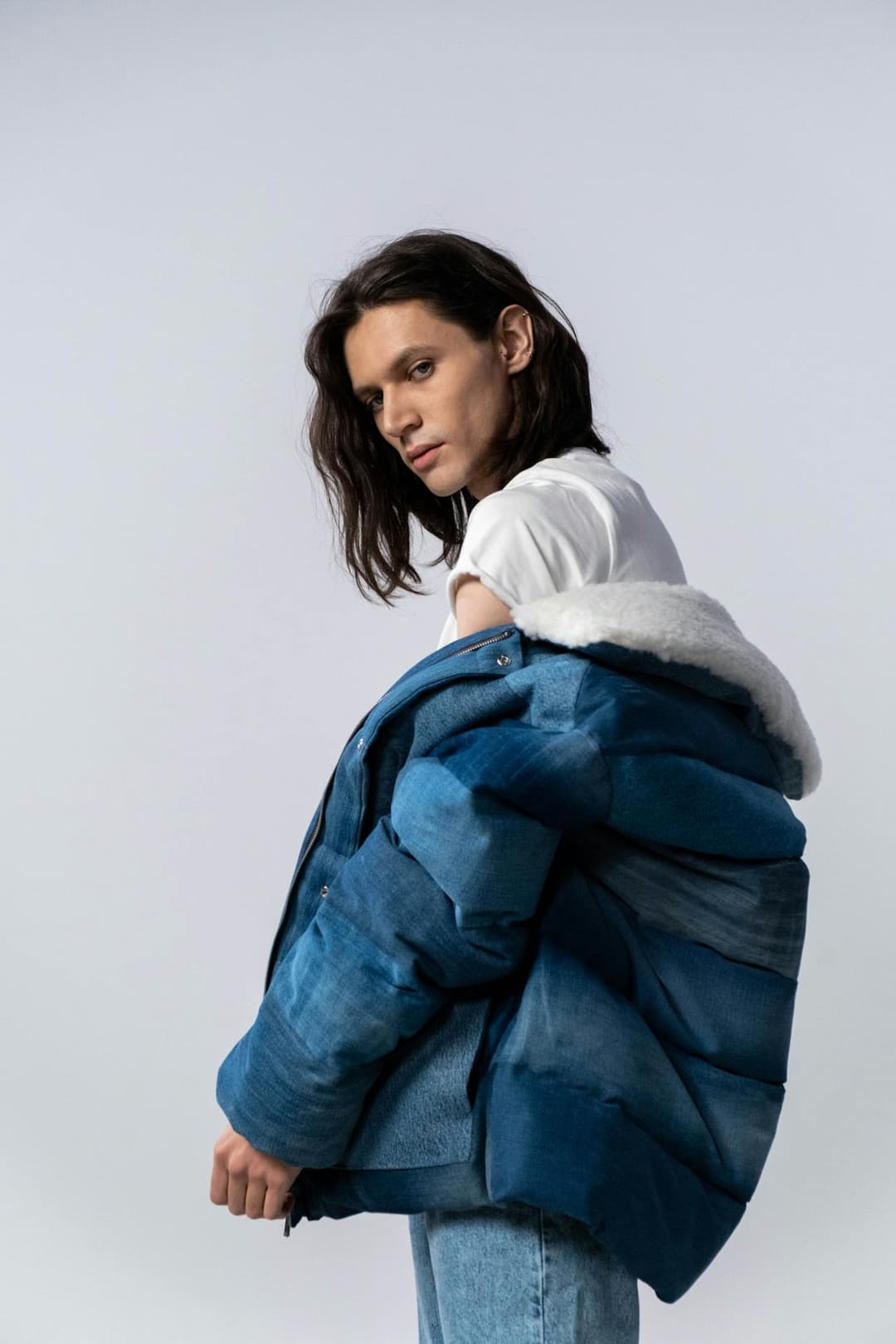Man wearing an indigo denim puffer jacket
