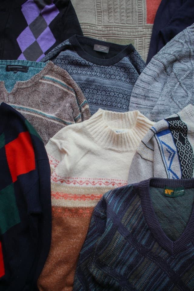 Pile of patterned knit sweaters