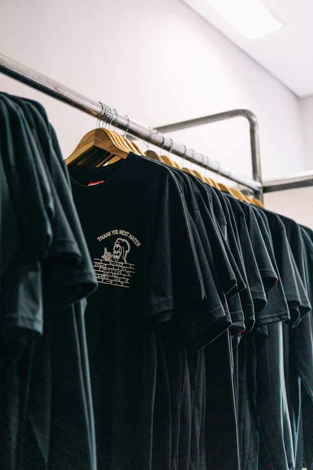 Black printed t-shirts hanging on a rail