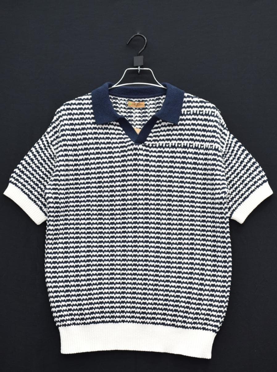 Navy and white striped knit polo on a hanger