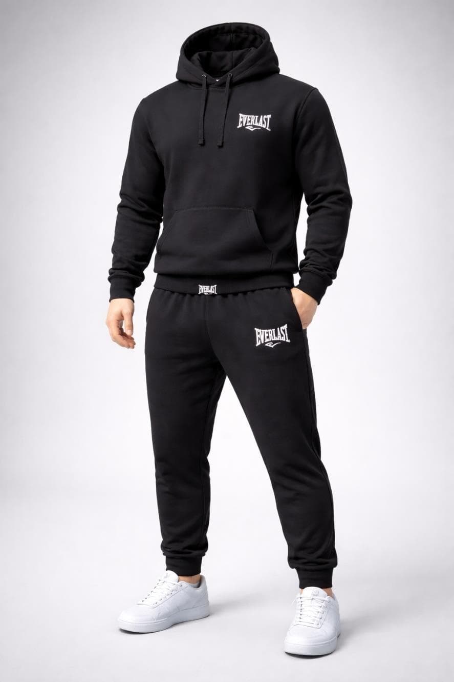 Model wearing a black hooded sweatshirt and matching joggers