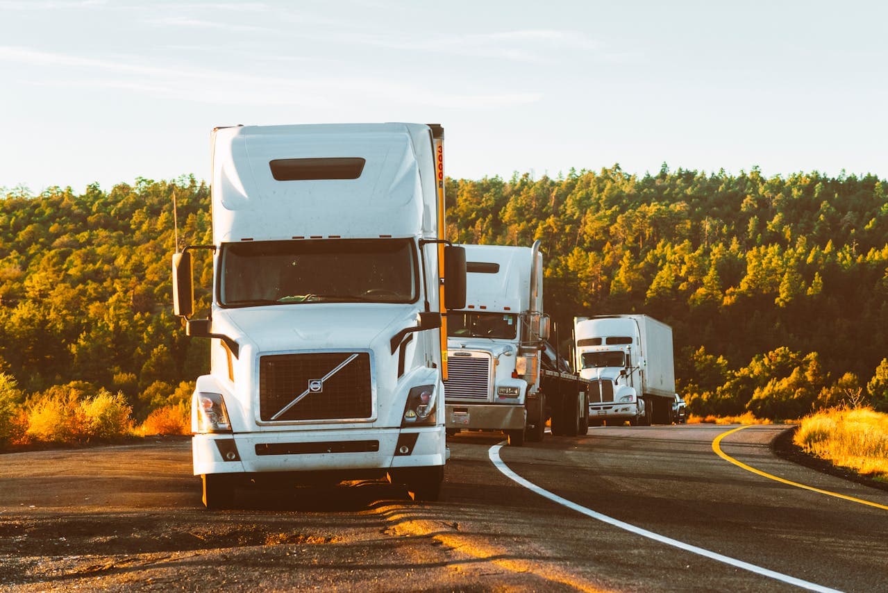 Freight trucks on a highway at sunset