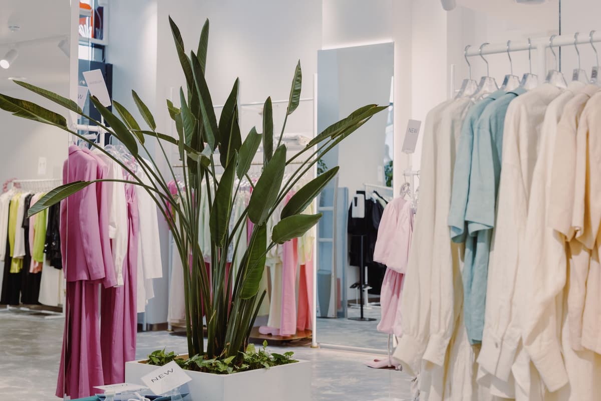 Sample garments merchandised on rails in a bright showroom