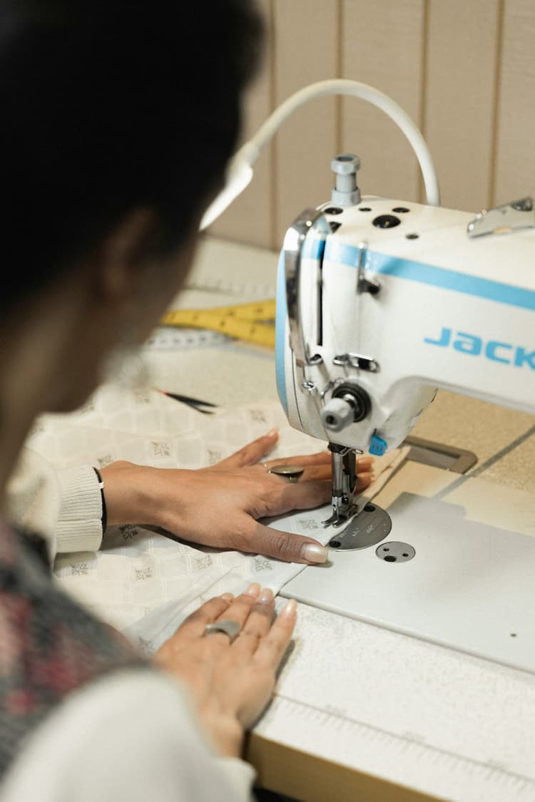 Machinist stitching fabric on an industrial sewing machine